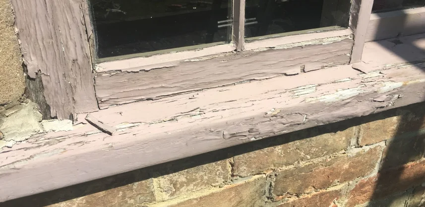 Flaking, cracked paint on all parts of window frame